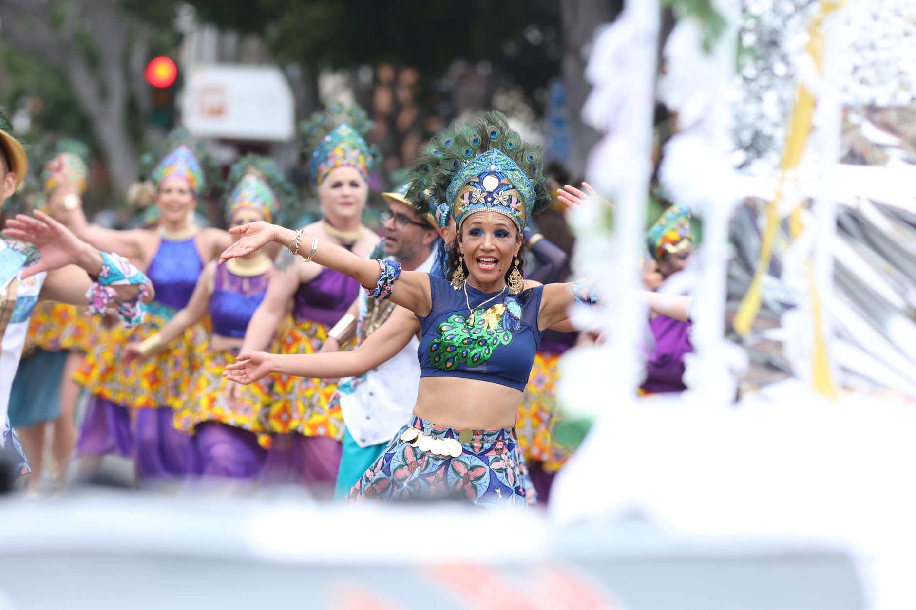 a group of dancers in traditional clothing at a parade during a festival